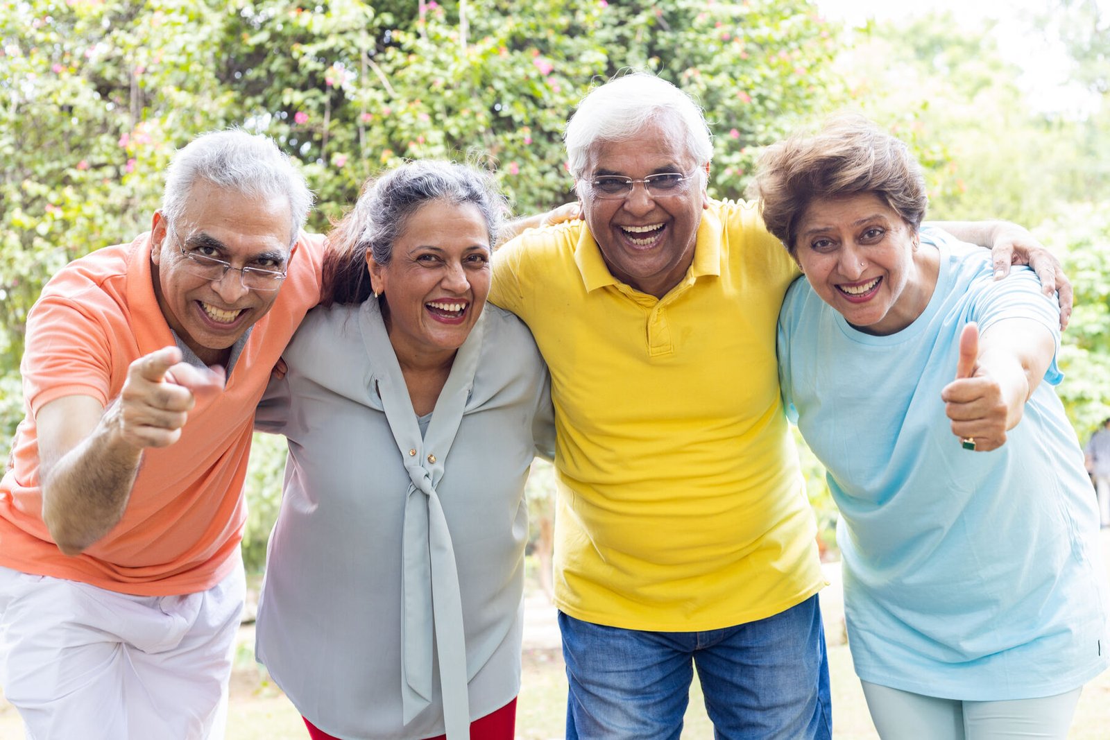 A group of happy senior friends laughing together in a park